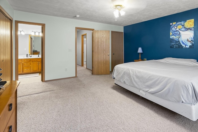 8 Harrison Ct, Bloomington, IL 61704 - bedroom with light carpet, a textured ceiling, connected bathroom, and baseboards