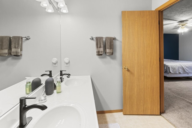 8 Harrison Ct, Bloomington, IL 61704 - ensuite bathroom featuring a ceiling fan, double vanity, and baseboards