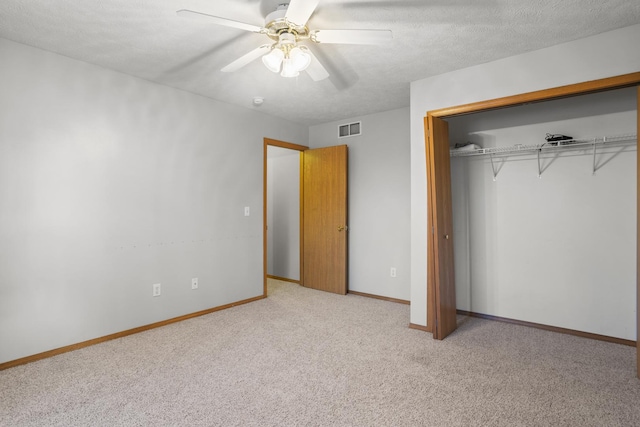 8 Harrison Ct, Bloomington, IL 61704 - unfurnished bedroom featuring carpet floors, a closet, baseboards, and ceiling fan