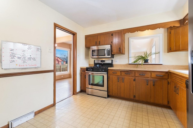 12217 S 68th Ct, Palos Heights, IL 60463 - kitchen featuring stainless steel appliances, a baseboard radiator, light flooring, and light countertops