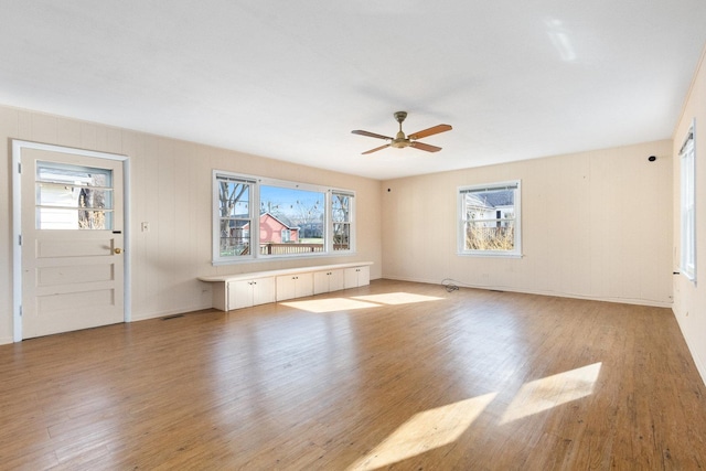 12217 S 68th Ct, Palos Heights, IL 60463 - unfurnished living room featuring light wood-style flooring, ceiling fan, and baseboards