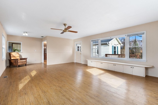 12217 S 68th Ct, Palos Heights, IL 60463 - unfurnished living room featuring light wood-style flooring and a ceiling fan