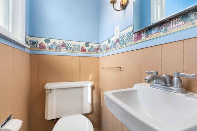 12217 S 68th Ct, Palos Heights, IL 60463 - half bathroom featuring a sink, a decorative wall, toilet, and wainscoting