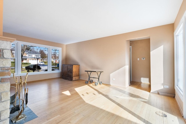 12217 S 68th Ct, Palos Heights, IL 60463 - unfurnished living room featuring wood finished floors, healthy amount of natural light, and a stone fireplace