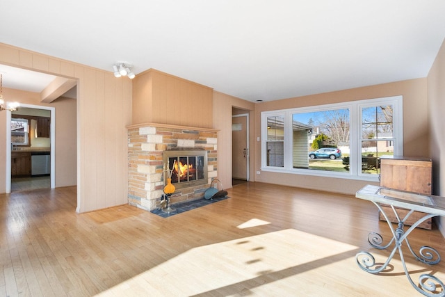 12217 S 68th Ct, Palos Heights, IL 60463 - living room with wood finished floors, a stone fireplace, and a chandelier