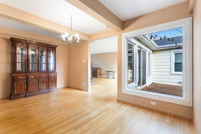 12217 S 68th Ct, Palos Heights, IL 60463 - unfurnished dining area featuring a chandelier, light wood-style floors, and baseboards