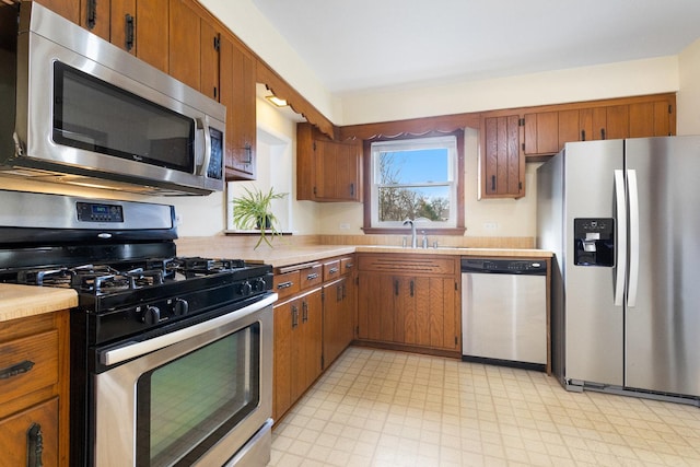 12217 S 68th Ct, Palos Heights, IL 60463 - kitchen with stainless steel appliances, light countertops, a sink, and brown cabinets
