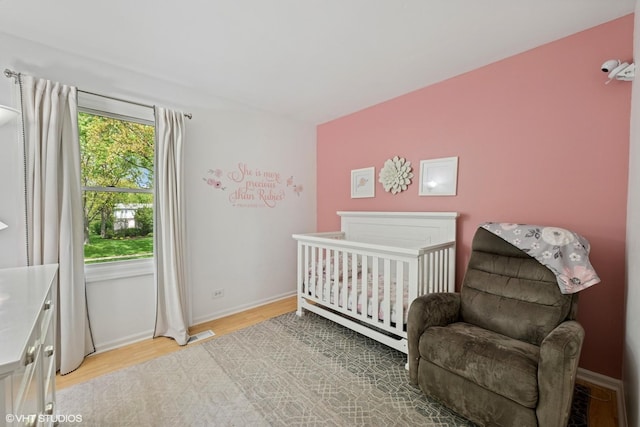 153 E Timberlane Dr, Palatine, IL 60067 - bedroom with light wood finished floors, baseboards, and a crib