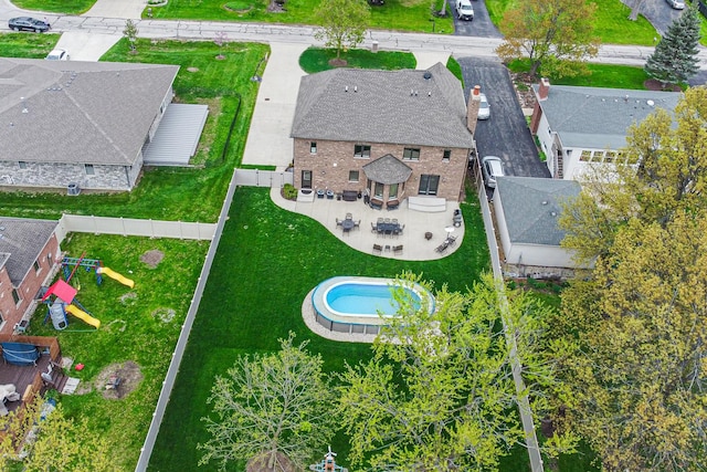 aerial view of property and surrounding area featuring a pool