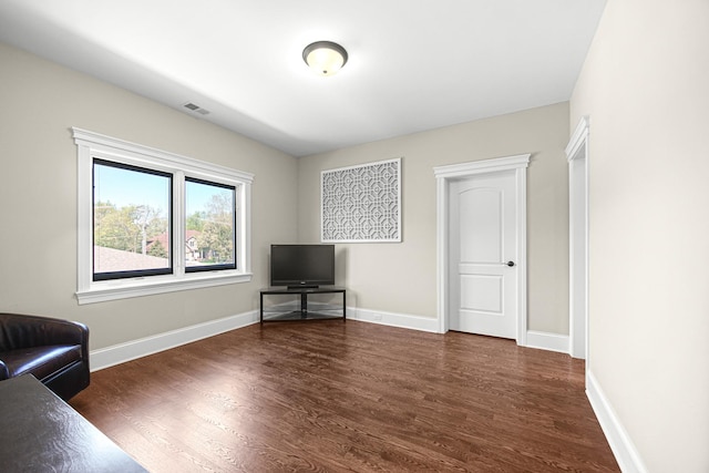 living area with wood finished floors and baseboards