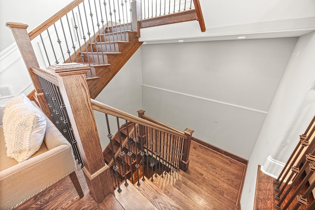 staircase with wood finished floors and baseboards