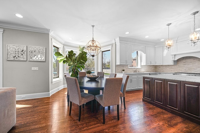 dining room with a chandelier, plenty of natural light, crown molding, recessed lighting, and baseboards