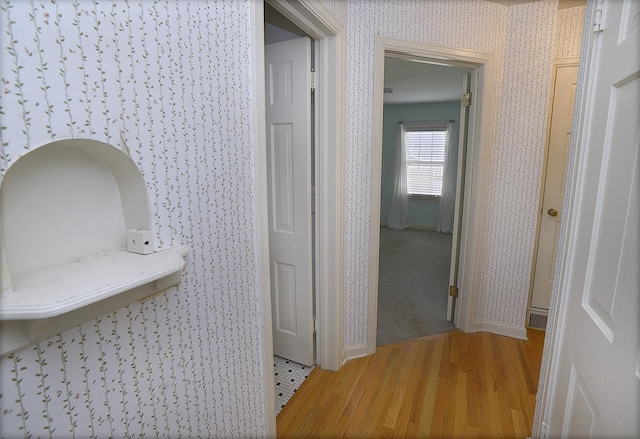 122 W Allen St, Ottawa, IL 61350 - hallway with wallpapered walls, light wood-style floors, and baseboards