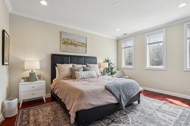 bedroom with wood finished floors, crown molding, baseboards, and recessed lighting
