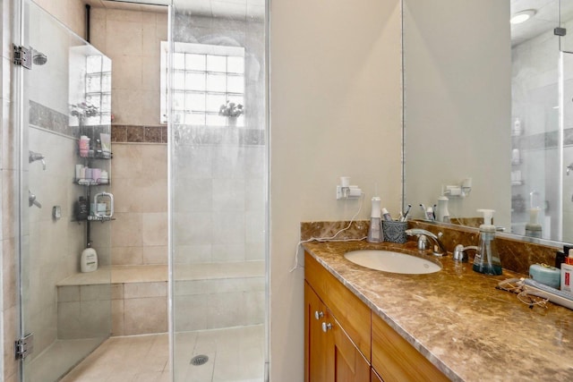 full bath with a stall shower and vanity