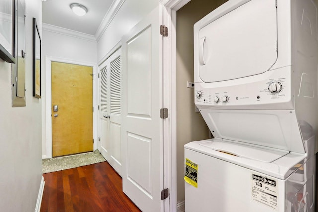 laundry area with stacked washer and clothes dryer, crown molding, and dark wood-style floors