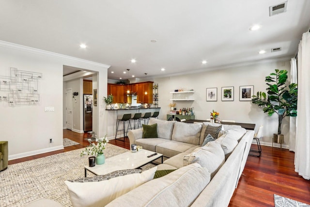 living area with dark wood-type flooring, recessed lighting, baseboards, and crown molding