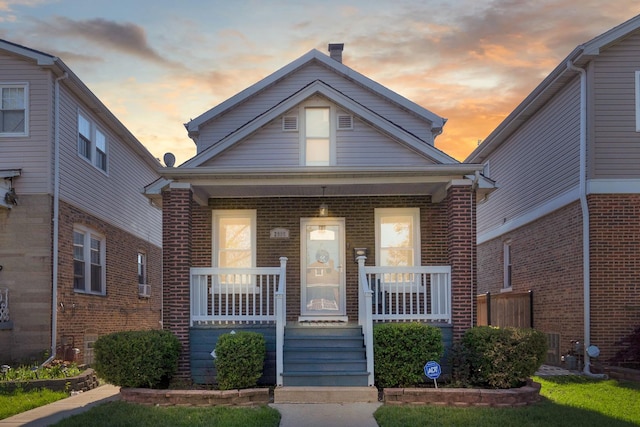 2906 N Menard Ave, Chicago, IL 60634 - view of front of house featuring a porch, brick siding, and a chimney