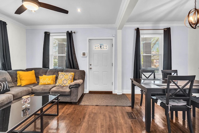 2906 N Menard Ave, Chicago, IL 60634 - living area featuring plenty of natural light, dark wood finished floors, a ceiling fan, baseboards, and ornamental molding