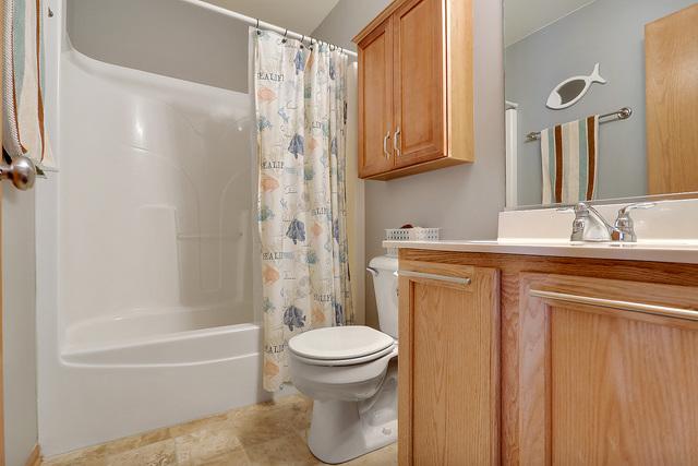 full bathroom featuring toilet, vanity, and shower / bath combo with shower curtain