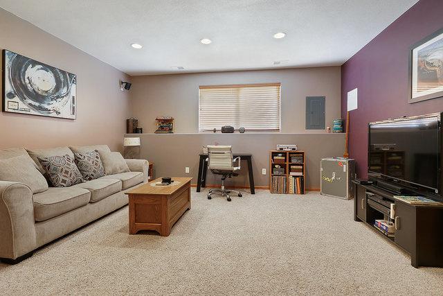 living area with carpet flooring, recessed lighting, an office area, and baseboards