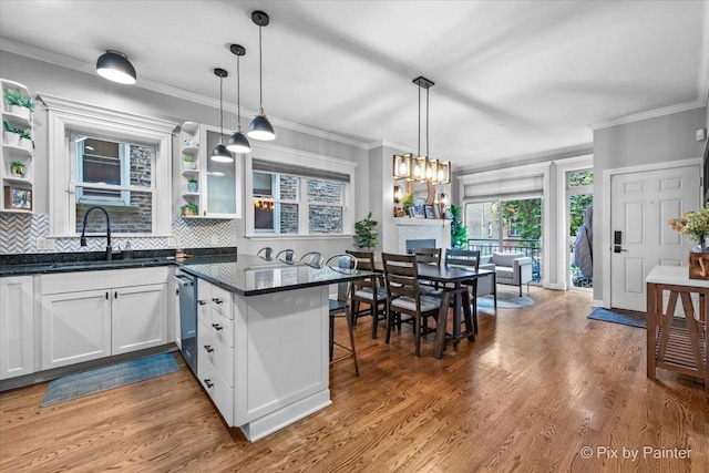 2447 W Walton St Unit 1, Chicago, IL 60622 - kitchen with a sink, open shelves, backsplash, white cabinetry, and crown molding