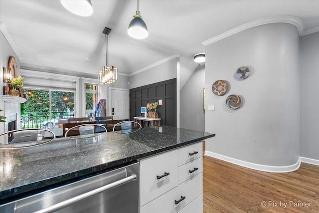 2447 W Walton St Unit 1, Chicago, IL 60622 - kitchen with stainless steel dishwasher, ornamental molding, white cabinetry, wood finished floors, and pendant lighting