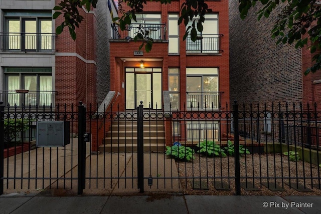 2447 W Walton St Unit 1, Chicago, IL 60622 - view of front of home with brick siding and a fenced front yard