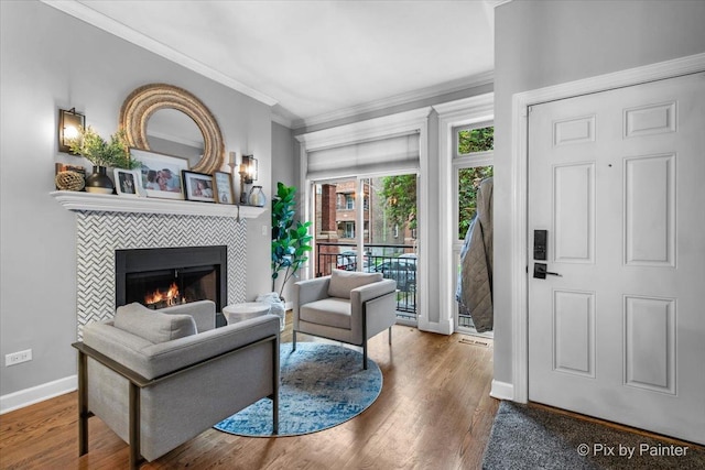 2447 W Walton St Unit 1, Chicago, IL 60622 - living area featuring a tile fireplace, crown molding, wood finished floors, and baseboards