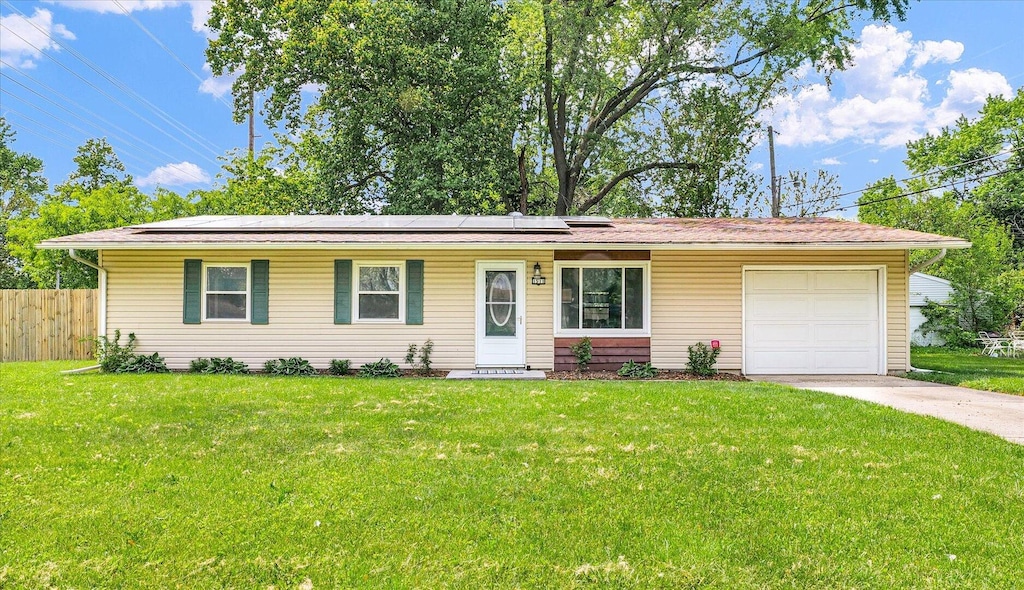 1511 Westfield Dr, Champaign, IL 61821 - ranch-style home featuring an attached garage, concrete driveway, and solar panels