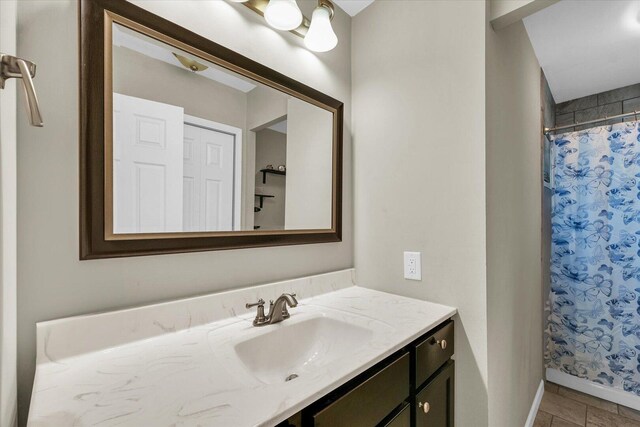 bathroom featuring vanity, baseboards, and a shower with curtain