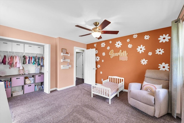 carpeted bedroom with a closet, baseboards, ceiling fan, and wallpapered walls