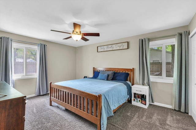 carpeted bedroom with multiple windows, baseboards, and ceiling fan