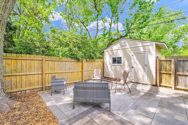 view of patio featuring a fenced backyard, an outdoor structure, and a storage shed