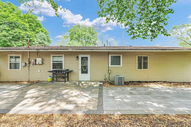 rear view of house with cooling unit and a patio area