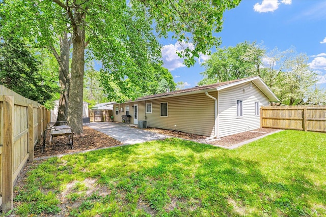 back of property with cooling unit and a patio area