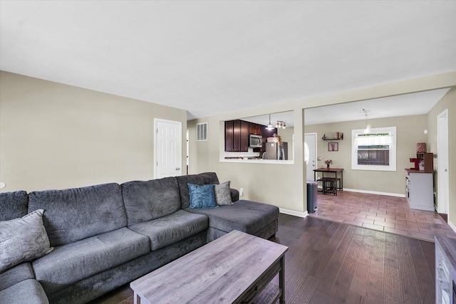 living area with dark wood finished floors and baseboards