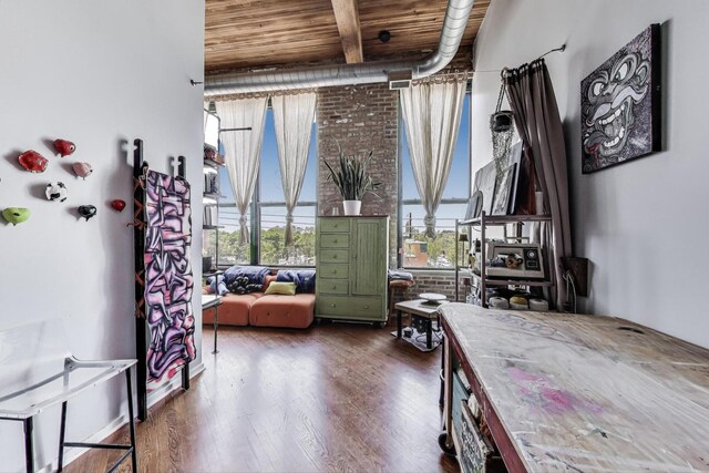 sitting room with healthy amount of natural light, wood finished floors, and wooden ceiling