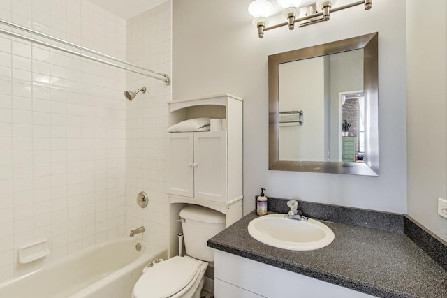 bathroom featuring toilet,  shower combination, and vanity