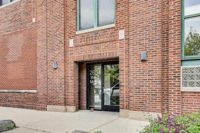 entrance to property with brick siding