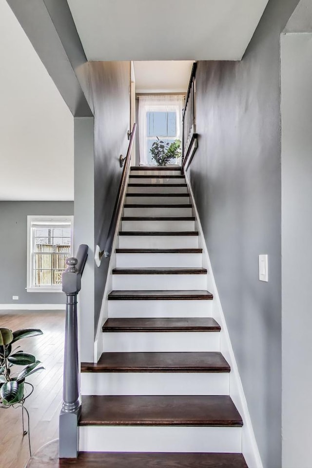 stairway featuring wood finished floors and baseboards