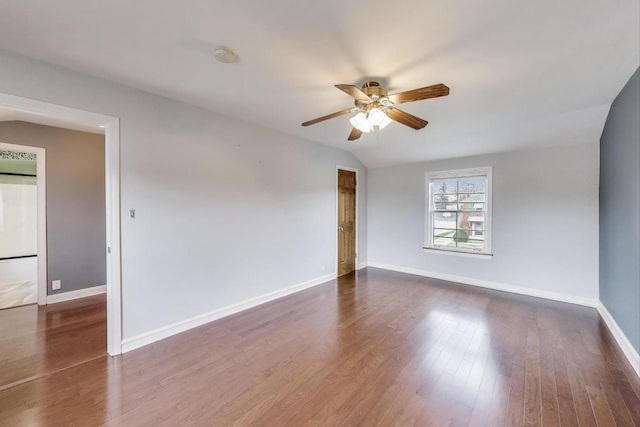 empty room with a ceiling fan, baseboards, dark wood finished floors, and a smoke detector