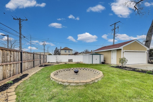 view of yard with an outbuilding, a detached garage, and a storage shed