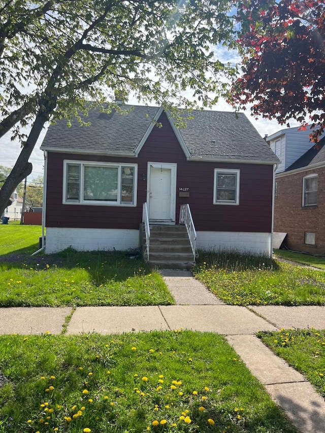 14027 S Mackinaw Ave, Burnham, IL 60633 - bungalow-style home featuring a front lawn and a shingled roof