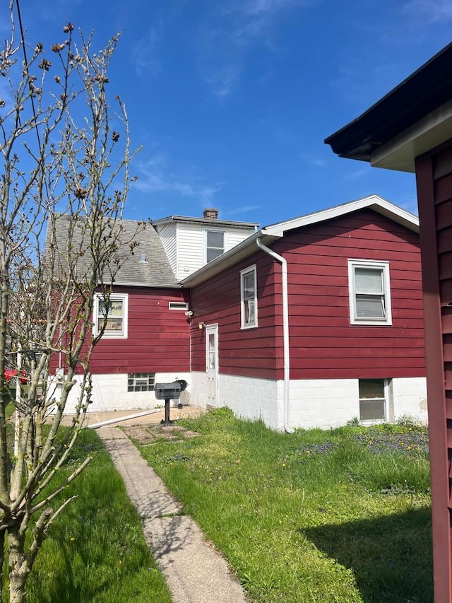 14027 S Mackinaw Ave, Burnham, IL 60633 - view of property exterior with a lawn and a chimney
