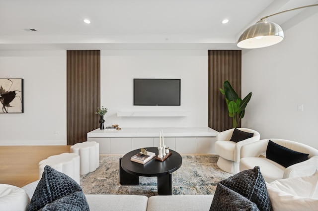 living area featuring wood finished floors, recessed lighting, and baseboards