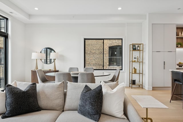 living room featuring light wood-style flooring and recessed lighting