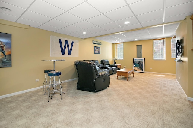 carpeted living room with a drop ceiling, baseboards, and recessed lighting