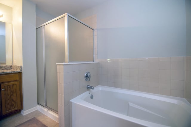 full bath featuring vanity, a stall shower, a bath, and tile patterned floors