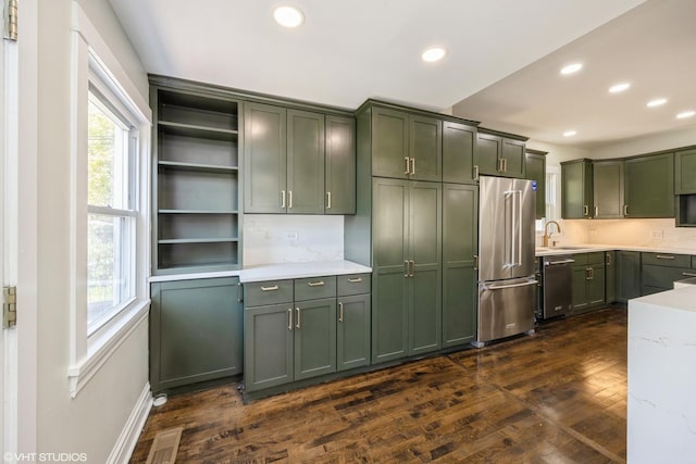 605 Home Ave, Oak Park, IL 60304 - kitchen with appliances with stainless steel finishes, green cabinetry, a sink, open shelves, and light countertops